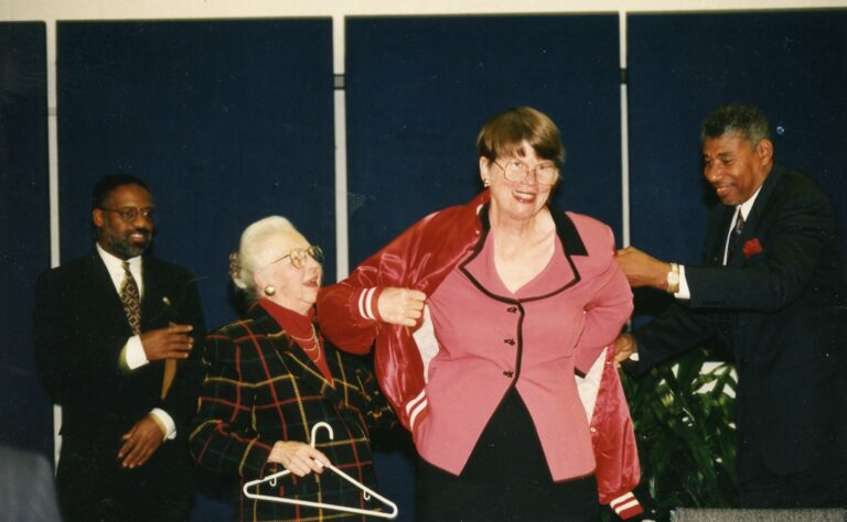 Jan Reno receiving her CARE Team  red jacket